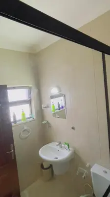a bathroom with a white sink and a window at شقة مفروشة في طبربور in Amman
