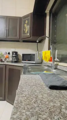 a kitchen counter with a sink and a kitchen sink at شقة مفروشة في طبربور in Amman