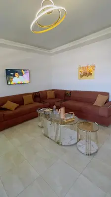 a living room with a couch and two tables at شقة مفروشة في طبربور in Amman
