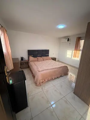 a bedroom with a bed and a tiled floor at petra towering rock in Wadi Musa