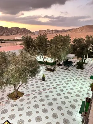 an aerial view of a patio with trees and a boat at petra towering rock in Wadi Musa