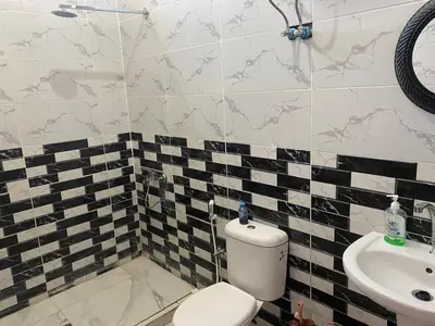 a bathroom with a toilet and a sink at هوستل خدمه مبيت in Disah