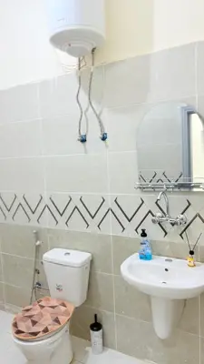 a bathroom with a toilet and a sink at هوستل خدمه مبيت in Disah