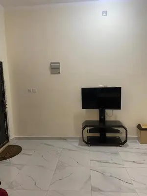 a computer monitor sitting on a chair in a room at هوستل خدمه مبيت in Disah