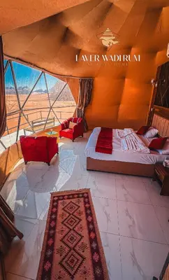 a room with two beds and a rug in a room at Laver wadi rum in Wadi Rum