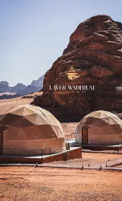 two tents in the desert with a mountain in the background at Laver wadi rum in Wadi Rum