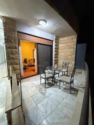 a dining room with a table and chairs at Abdallah Wa'el Adham in Aqaba
