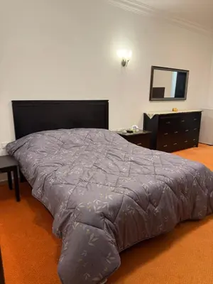 a large bed in a room with a large bed sidx sidx at Abdallah Wa'el Adham in Aqaba