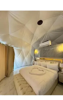 a bedroom with a large bed in a tent at Rum Desert Silence Camp in Wadi Rum