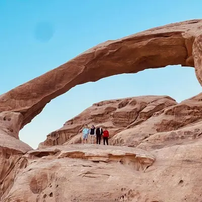 a group of people standing under an arch at Rum Desert Silence Camp in Wadi Rum
