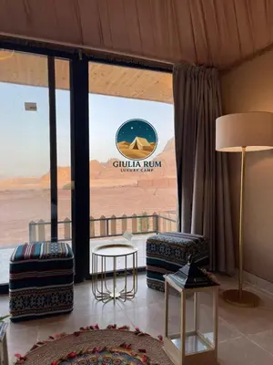 a living room with a view of the desert at Giulia Rum Luxury Camp in Wadi Rum