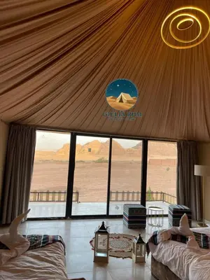 a bedroom with a view of the desert from inside a tent at Giulia Rum Luxury Camp in Wadi Rum