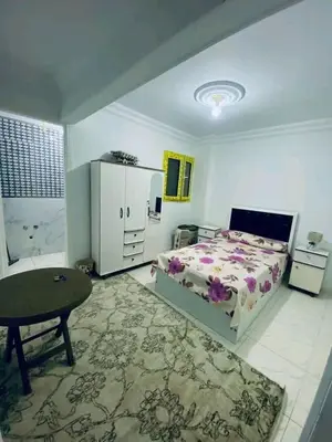 a bedroom with a bed and a chair and a table at Vrtn hotel in Amman