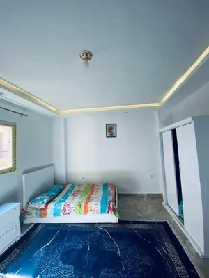 a bedroom with a bed in the corner of a room at Vrtn hotel in Amman