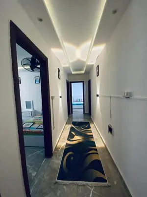 a room with a hallway with a painting on the floor at Vrtn hotel in Amman