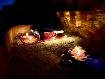 a train with candles in a cave at night at Fire bedouin camp in Wadi Rum