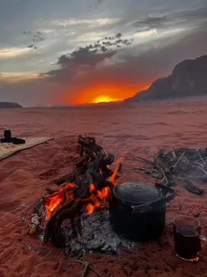 a pot over a camp fire in the desert at Rum Tale Camp in Wadi Rum
