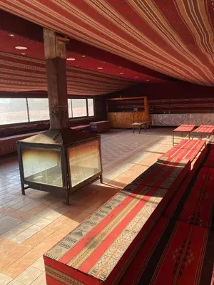 a large room with a table and benches in it at Rum Tale Camp in Wadi Rum