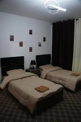 a bedroom with two beds and a ceiling at Petra Bed Hostel in Petra