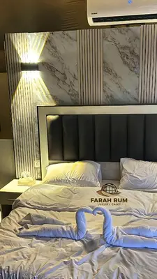 a bed in a hotel room with a sign on it at FARAH RUM LUXURY CAMP & Bubbles Hotel in Wadi Rum
