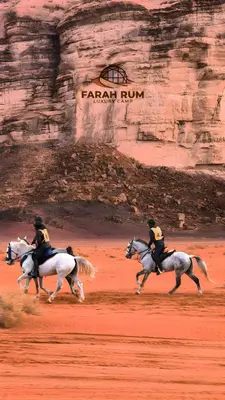 a group of people riding horses in the desert at FARAH RUM LUXURY CAMP & Bubbles Hotel in Wadi Rum