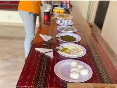 a long table with plates of food on it at Rum Adventure Camp in Wadi Rum