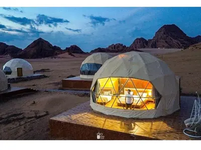 a man standing in a tent in the desert at Rum Adventure Camp in Wadi Rum