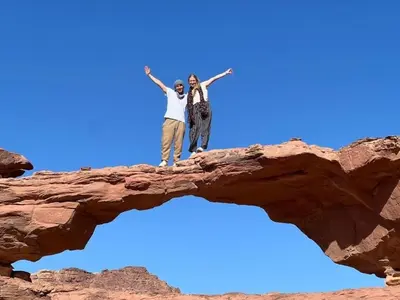 two people standing on top of a rock formation at Rum Adventure Camp in Wadi Rum