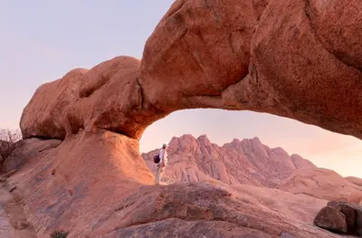 a person standing on top of a rock formation at Rum Adventure Camp in Wadi Rum
