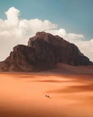 a mountain with two people on a boat in the desert at Silent Sands Lodge in Disah