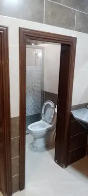 a bathroom with a white toilet and a sink at Petra sharing room in Petra