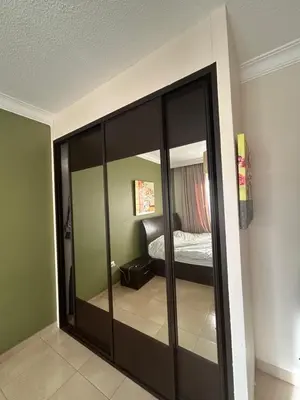 a room with a glass closet with a bed in it at Luxury Apartment for Daily Rent in Shmaisani in Amman