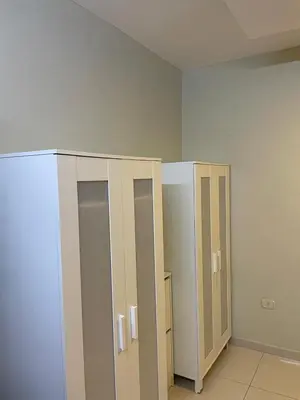 an empty room with two stalls in a room at Al qaoud apartment in Aydūn