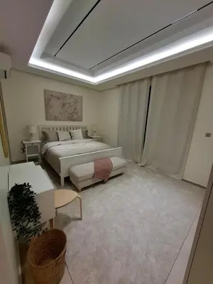 a bedroom with a bed and a couch and a table at كمباوند شقة مفروشة كومباوند الامعري المطار 222 in Amman