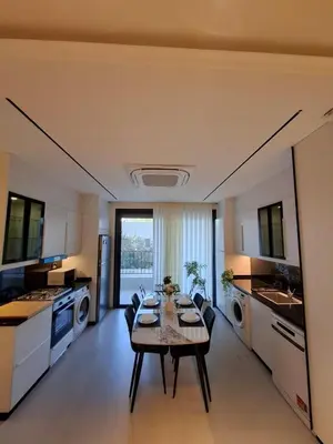 a large kitchen with a table and chairs in it at كمباوند شقة مفروشة كومباوند الامعري المطار 222 in Amman