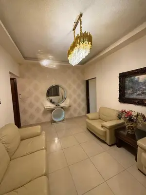 a living room with a couch and a chandelier at Furnished luxuries Apartment with a Stunning View in Amman