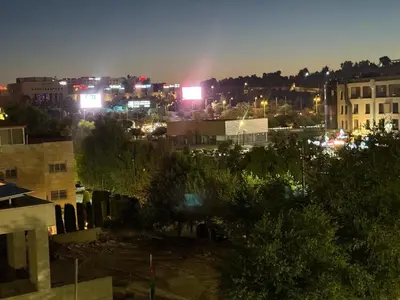 a view of a city at night with lights at Furnished luxuries Apartment with a Stunning View in Amman