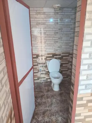 a bathroom with a toilet in a brick wall at Ayed Wadi Rum camp in Wadi Rum