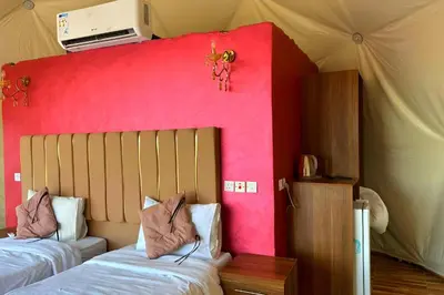 a bedroom with two beds and a pink wall at Desert Oasis in Wadi Rum Village - Cozy Lodge Room in Aqaba