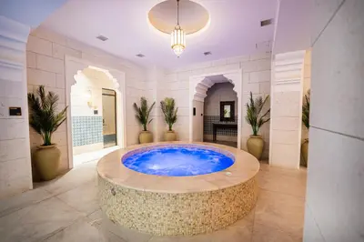 a large bathroom with a large blue tub in a room at طريق المطار بوليفارد الامعري in Amman