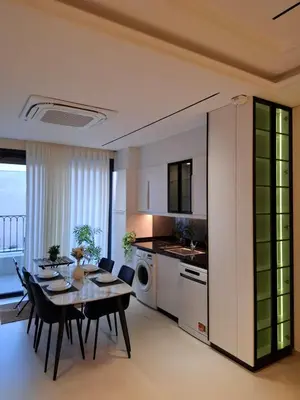 a kitchen and dining room with a table and chairs at طريق المطار بوليفارد الامعري in Amman
