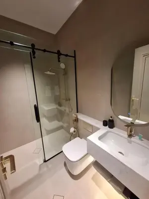 a bathroom with a shower and a toilet and a sink at طريق المطار بوليفارد الامعري in Amman