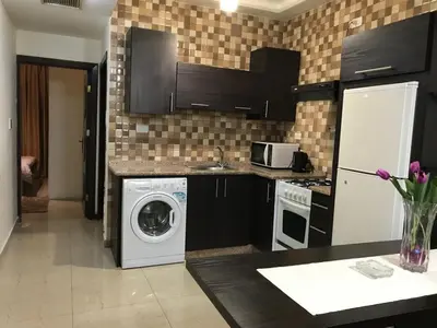 a kitchen with a washer and dryer in it at luxury apartment in amman, abdoun in Amman