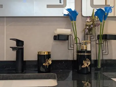 two vases with flowers in them on a kitchen counter at Noorhan Private Luxury Layover Villa - 10 Minutes to Airport in Amman