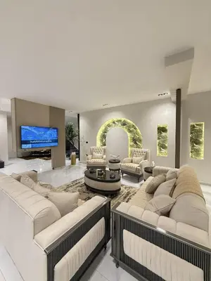 a living room with two couches and a tv at Noorhan Private Luxury Layover Villa - 10 Minutes to Airport in Amman