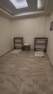 two beds in a room with a tile floor at السلام الشقق الفندقية peace hotel apartments in Aqaba