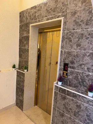 a door in a stone wall with two potted plants at السلام الشقق الفندقية peace hotel apartments in Aqaba