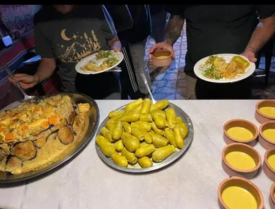 three plates of food on a table with plates of food at Peace House in Wadi Musa