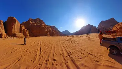 a man standing in the desert with a truck at Lunar scape haven in Wadi Rum