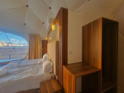 a bedroom with a bed with a view of the ocean at Lunar scape haven in Wadi Rum
